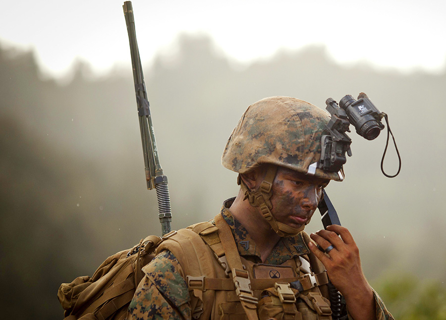 U.S. Marine Corps Cpl. Christopher Griffith a squad leader with Lima Company, 3rd Battalion, 4th Marine Regiment, conducts a radio check during the Advanced Infantry Course at Kahuku Training Area, Hawaii