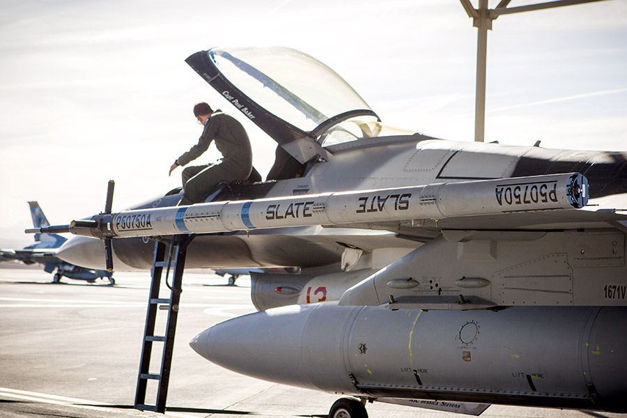 The Secure Live Virtual Constructive Advanced Training Environment LVC pod is attached to an F-16 with the 64th Aggressor Squadron during an Electromagnetic Interference/Compatibility test at Nellis Air Force Base, Nevada, during Phase I of the demonstration in June. (U.S. Air Force photo by William Graver)